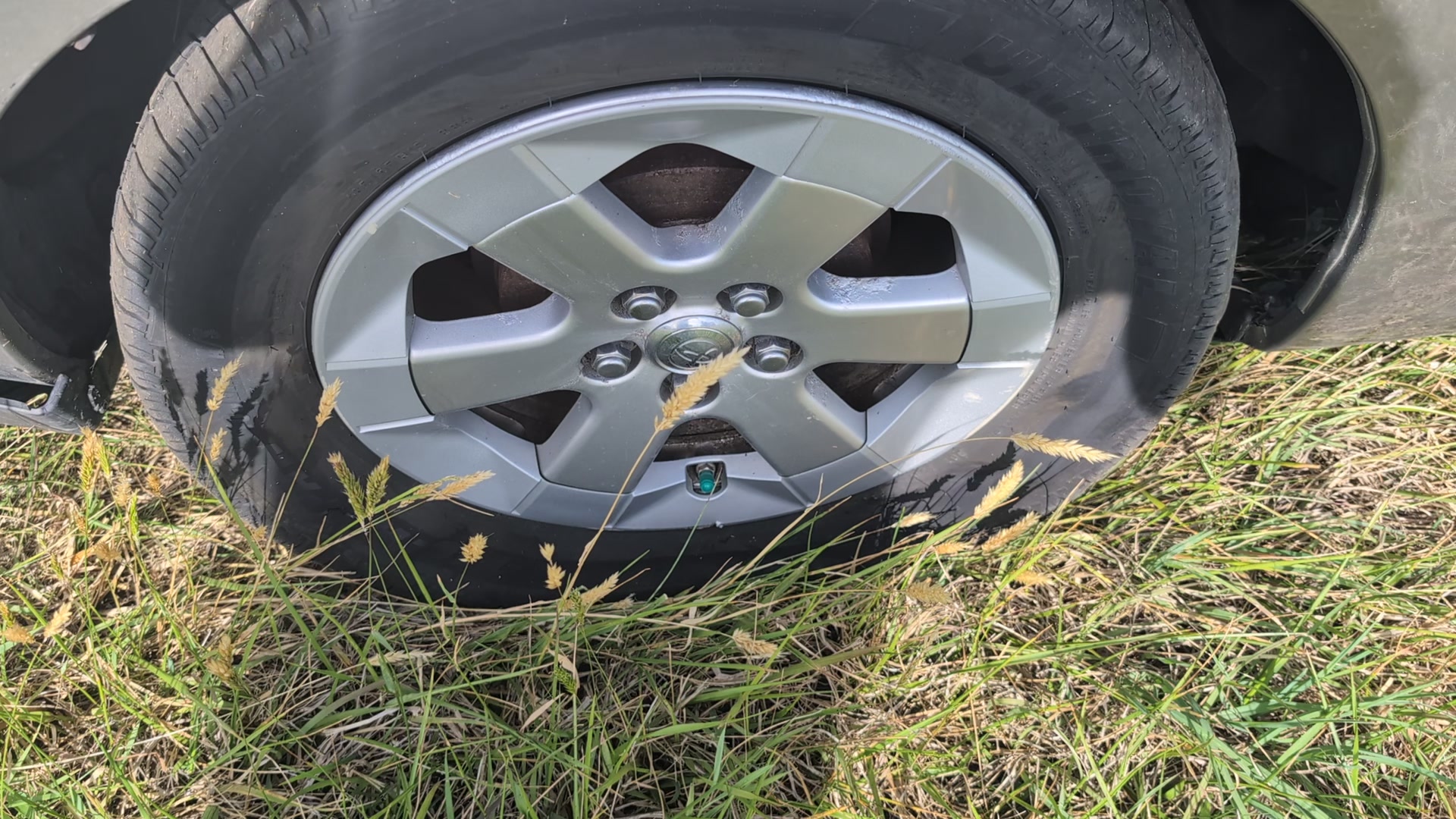 flat tire on the side of the road